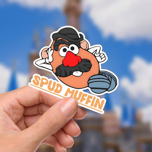 A Disney sticker featuring a cartoon character with a potato-shaped head, a black hat, mustache, and a red nose. The sticker has the text "SPUD MUFFIN" in orange letters.