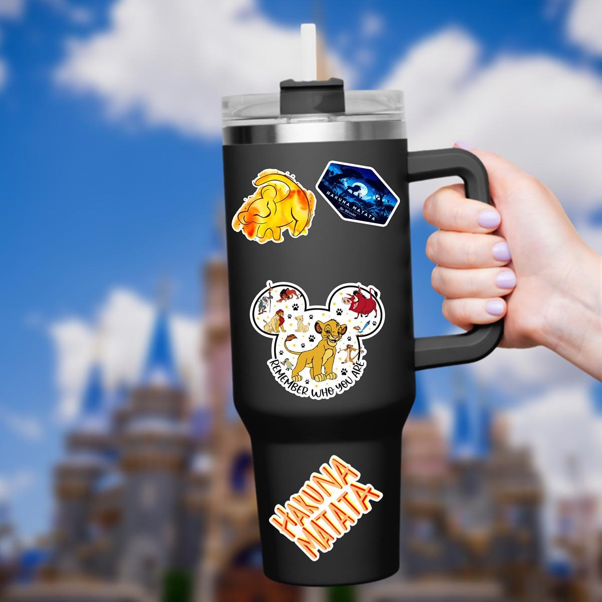 A Disney Lion King themed sticker in the shape of Mickey Mouse ears. The sticker features Simba, Timon, Pumbaa, and other characters. The sticker is yellow, red, and black with the words 'Remember Who You Are'.