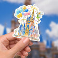 Disney World Castle Balloons TinkerBelle Laptop Sticker/ Magic Kingdom Fantasyland Disney decal/ planner water bottle cell phone decal A colorful Disney castle sticker held in a hand. The castle is painted with shades of blue, pink, and gold, featuring multiple turrets and a detailed facade. A fairy with green attire and wings hovers nearby, waving a wand. A cluster of balloons in yellow, blue, and pink floats above the castle.