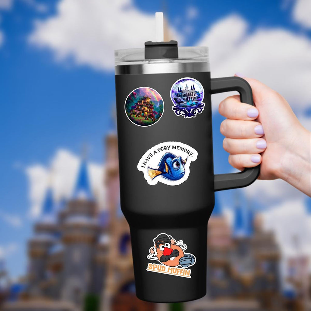 A sticker featuring Dory from Finding Nemo. The blue fish has large eyes and a yellow tail. The sticker has the text 'I have a Dory memory' in a curved white banner. The background is a blurred image of a castle and blue sky.