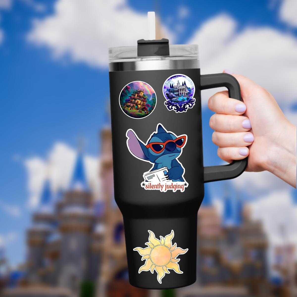 A blue Stitch sticker adult humor with red sunglasses and a newspaper. The sticker has the phrase 'silently judging' in a red, star-framed font. The background shows a blurred image of a blue sky and disney castle. Hydro bottle sticker, weather proof.