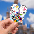 Disney sticker Mickey Mouse, Minnie Mouse, Donald Duck, Daisy Duck, Goofy, and Pluto in front of a castle.