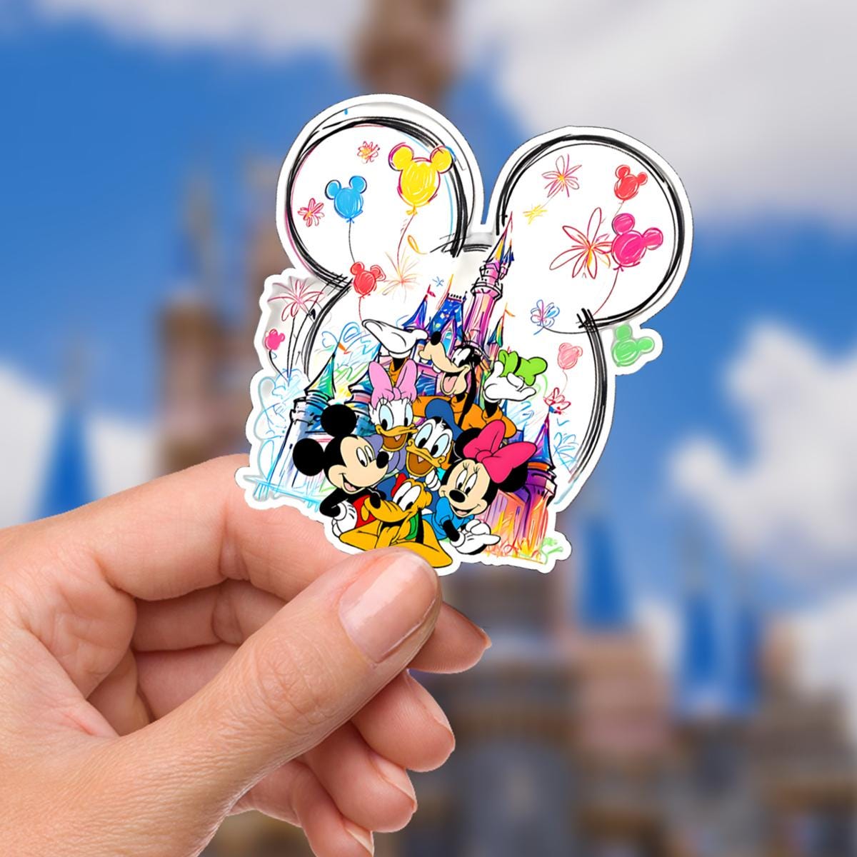 Disney sticker Mickey Mouse, Minnie Mouse, Donald Duck, Daisy Duck, Goofy, and Pluto in front of a castle.