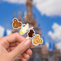 Disney Snacks, What A Wonderful World Sticker Waterproof Disney Laptop, Disneying Theme Park Vacation, Castle Park Mouse There's a Mickey Mouse pretzel, a soft-serve ice cream cone with a cherry, a chocolate-covered ice cream bar, and a Mickey Mouse waffle.